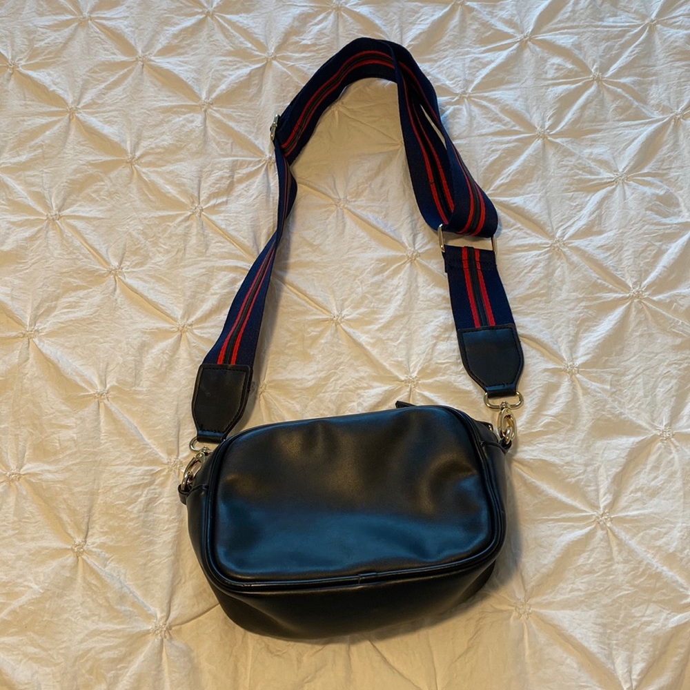 Black, multipurpose purse with navy blue/red adjustable and removable strap